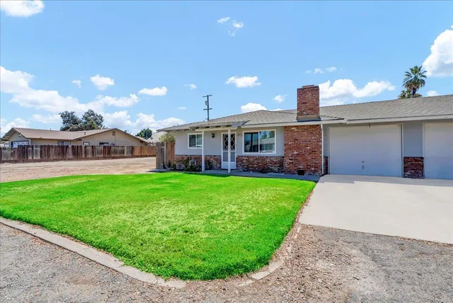a view of a house with a backyard and a garden