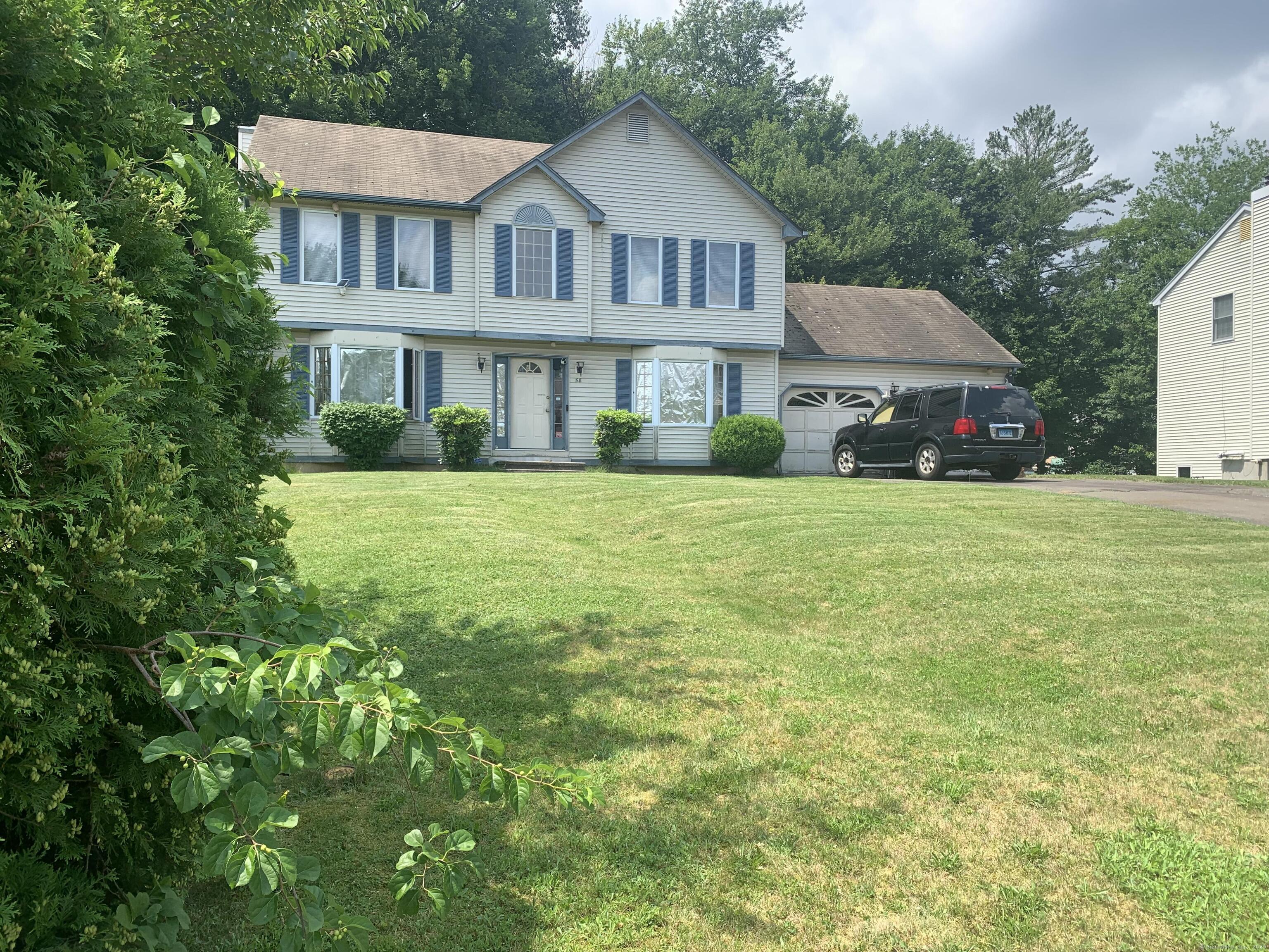 a front view of a house with a garden