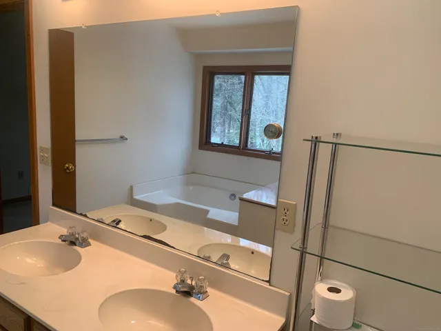 a bathroom with a sink toilet and mirror