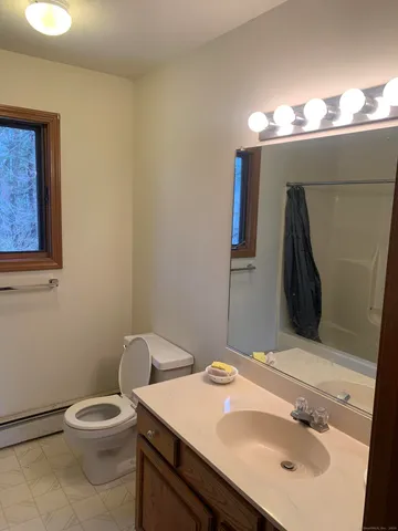 a bathroom with a sink toilet and a mirror