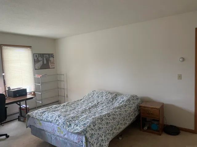 a bedroom with a workspace