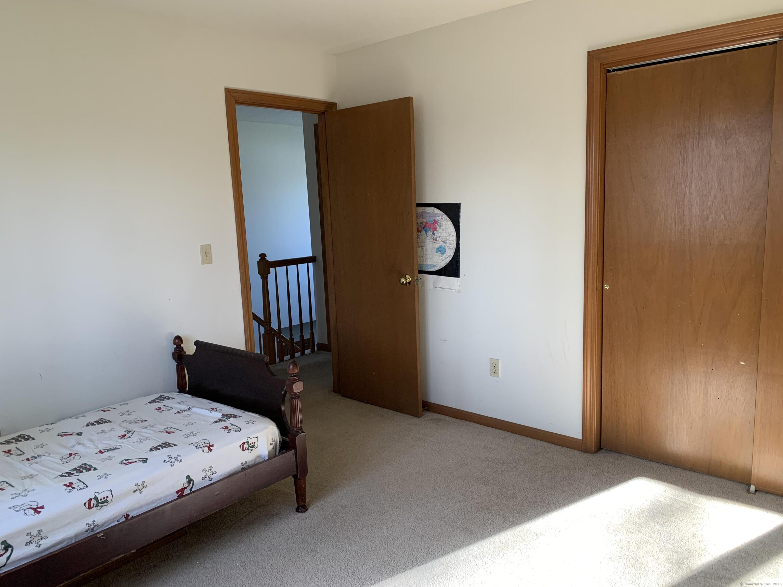58 Amanda Circle Windsor, CT 06095 - Photo 26 of 36 a bedroom with a bed and wooden floor