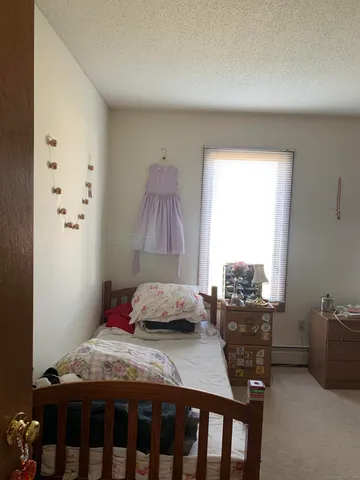 a view of a hallway to a livingroom with furniture