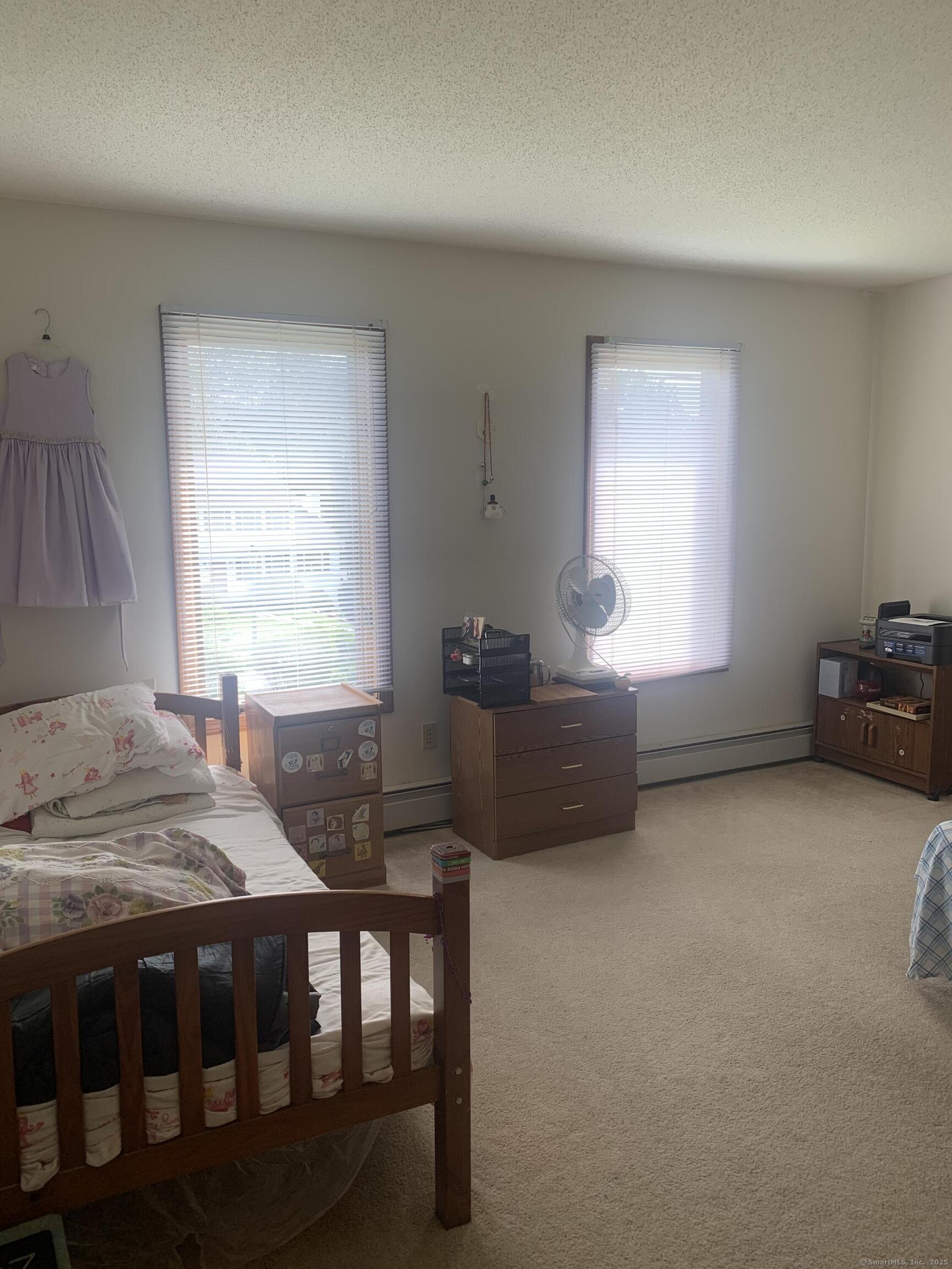 58 Amanda Circle Windsor, CT 06095 - Photo 31 of 36 a bedroom with a bed a table and windows