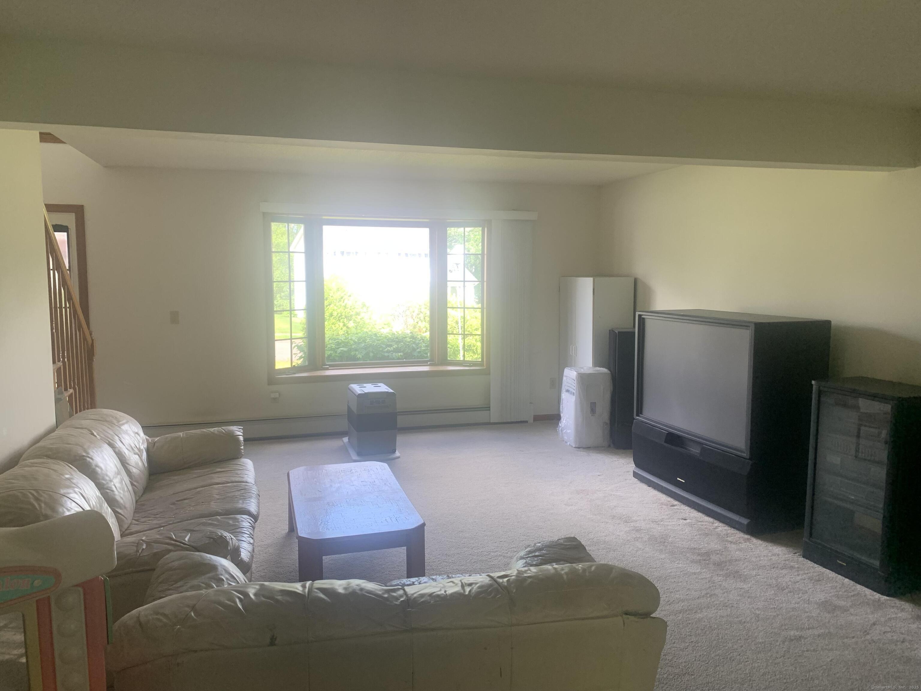 58 Amanda Circle Windsor, CT 06095 - Photo 32 of 36 a living room with furniture and a window
