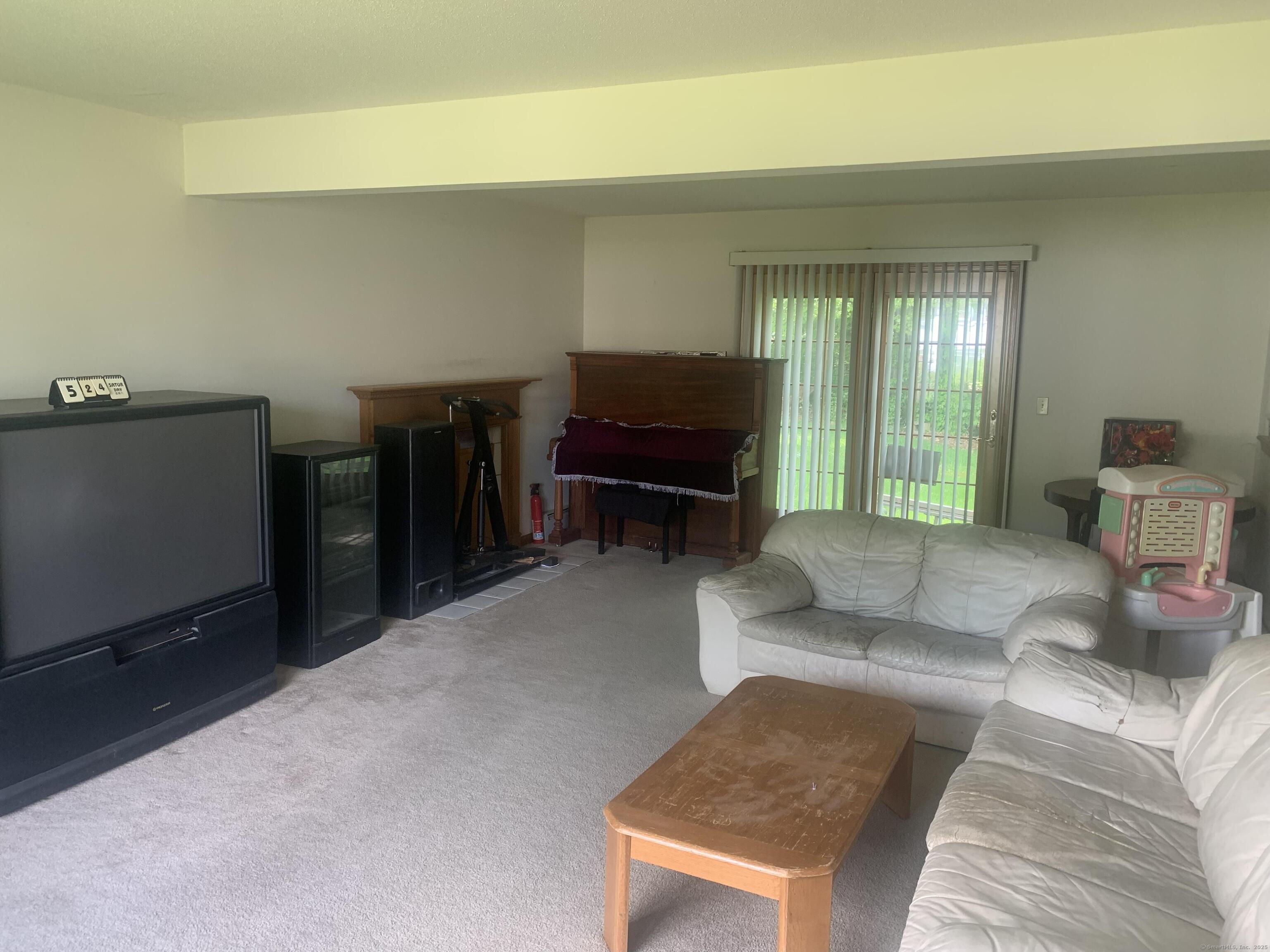 58 Amanda Circle Windsor, CT 06095 - Photo 35 of 36 a living room with furniture and a flat screen tv