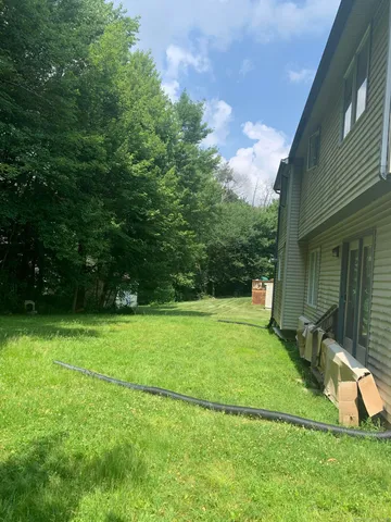 a view of a backyard with a garden and entertaining space