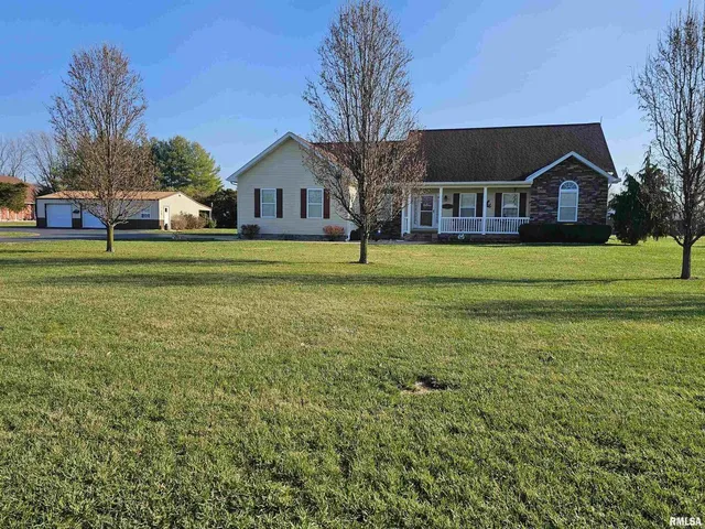a front view of house with yard and green space