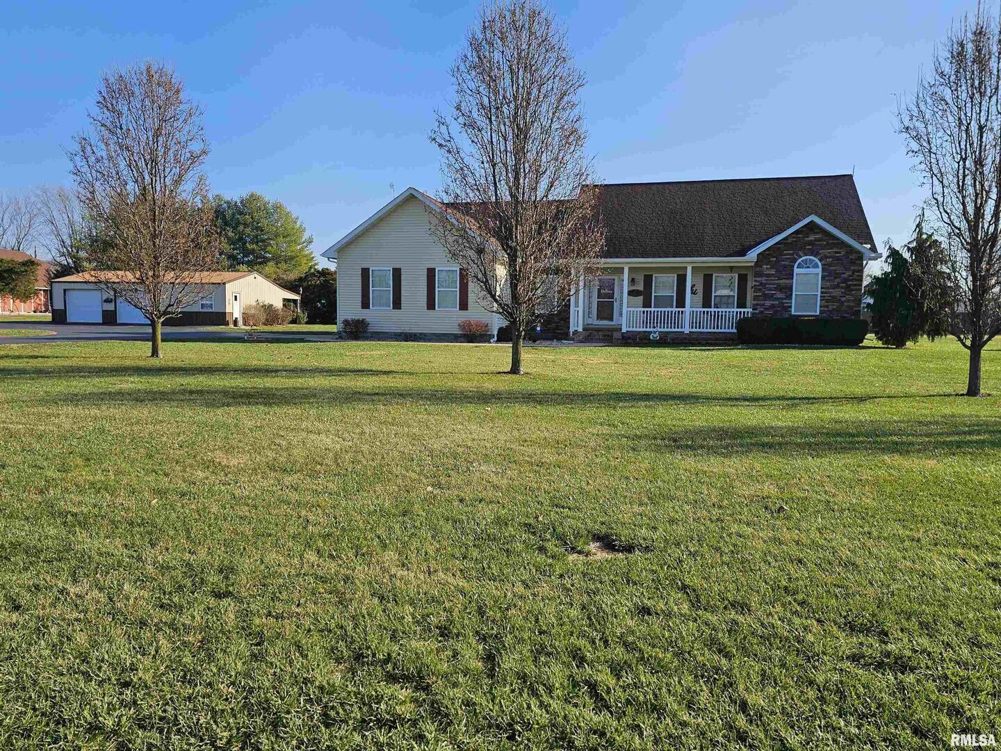 a front view of house with yard and green space