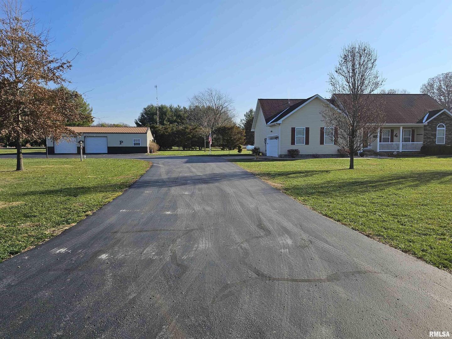 10586 North Spring Garden Lane Mount Vernon, IL 62864 - Photo 12 of 39 a front view of a house with a yard and garage