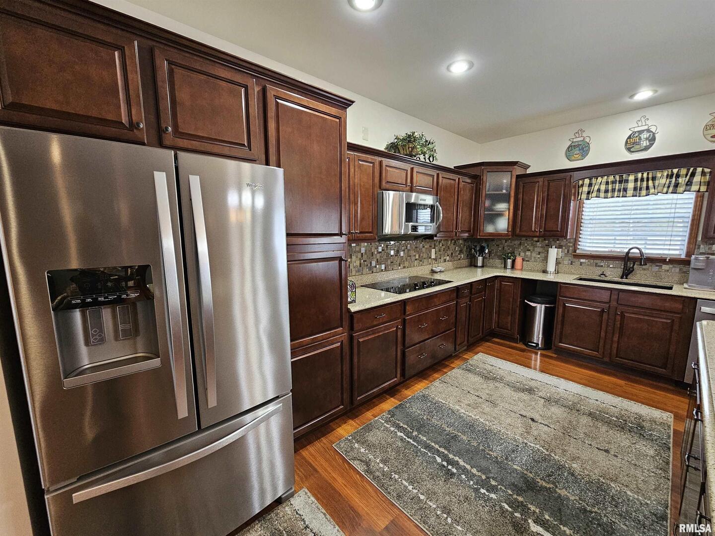 10586 North Spring Garden Lane Mount Vernon, IL 62864 - Photo 24 of 39 a kitchen with stainless steel appliances granite countertop a refrigerator a sink a stove a washer dryer and a refrigerator