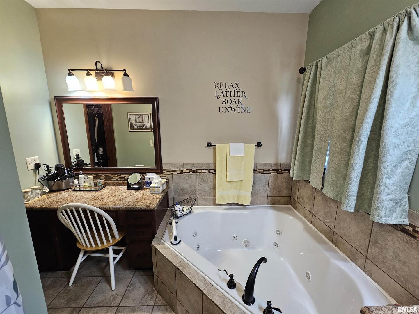 10586 North Spring Garden Lane Mount Vernon, IL 62864 - Photo 32 of 39 a bathroom with a tub sink and a mirror