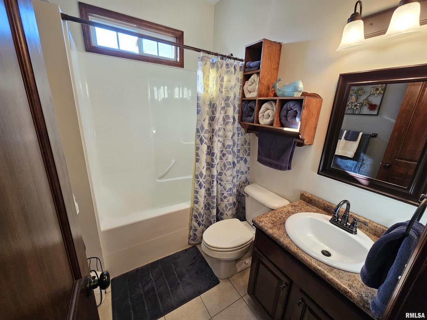 10586 North Spring Garden Lane Mount Vernon, IL 62864 - Photo 38 of 39 a bathroom with a sink a toilet a mirror and shower