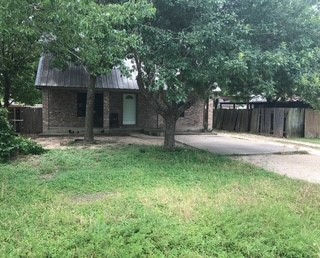 a view of a backyard with a tree