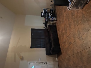 1017 West 3rd Street Taylor, TX 76574 - Photo 11 of 23 a living room with furniture a flat screen tv and a fireplace