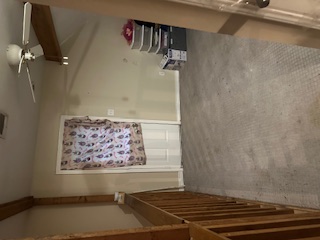1017 West 3rd Street Taylor, TX 76574 - Photo 13 of 23 a view of an empty room with stairs
