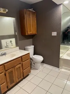 an empty room with closet and mirrors