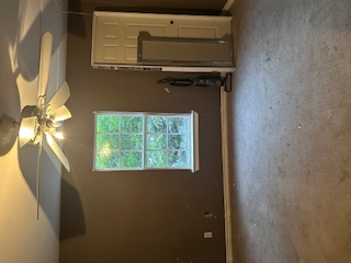 1017 West 3rd Street Taylor, TX 76574 - Photo 17 of 23 an empty room with windows and fan