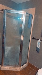 1017 West 3rd Street Taylor, TX 76574 - Photo 18 of 23 a bathroom with a glass shower door