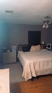 a bedroom with a bed and a mirror