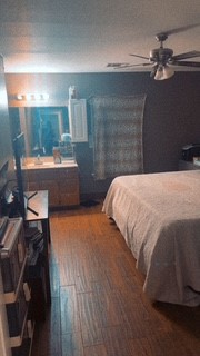 1017 West 3rd Street Taylor, TX 76574 - Photo 20 of 23 a bedroom with a bed and a mirror