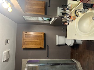 1017 West 3rd Street Taylor, TX 76574 - Photo 22 of 23 a bathroom with a sink toilet and shower