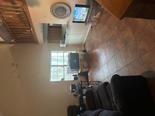 1017 West 3rd Street Taylor, TX 76574 - Photo 4 of 23 a living room with furniture and a large window