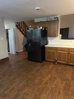 a kitchen with stainless steel appliances a sink a stove top oven a counter space and cabinets