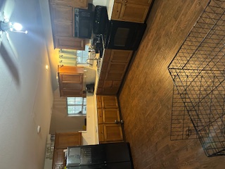 1017 West 3rd Street Taylor, TX 76574 - Photo 6 of 23 a kitchen with stainless steel appliances a sink a stove top oven a counter space and cabinets