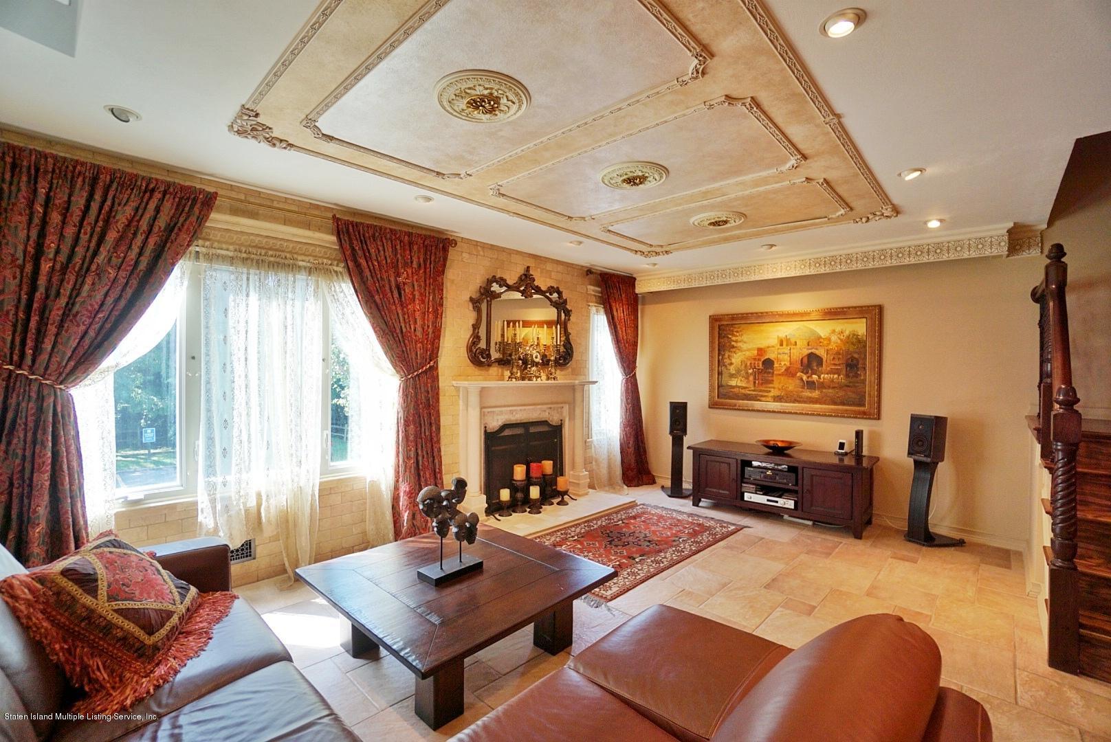 178 Admiralty Loop Staten Island, NY 10309 - Photo 12 of 50 a living room with furniture a fireplace and a large window