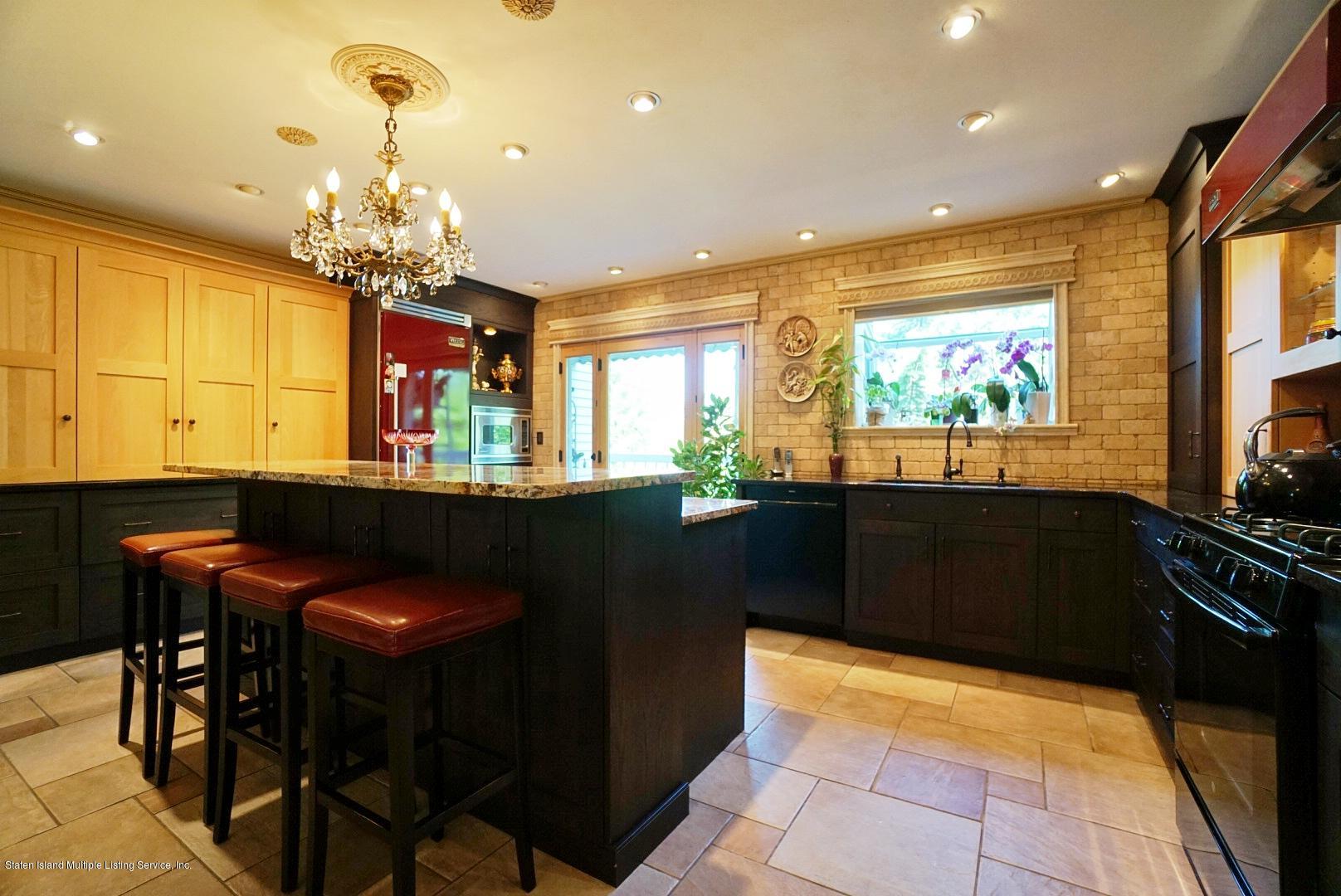 178 Admiralty Loop Staten Island, NY 10309 - Photo 17 of 50 a kitchen with stainless steel appliances kitchen island granite countertop a table and chairs in it