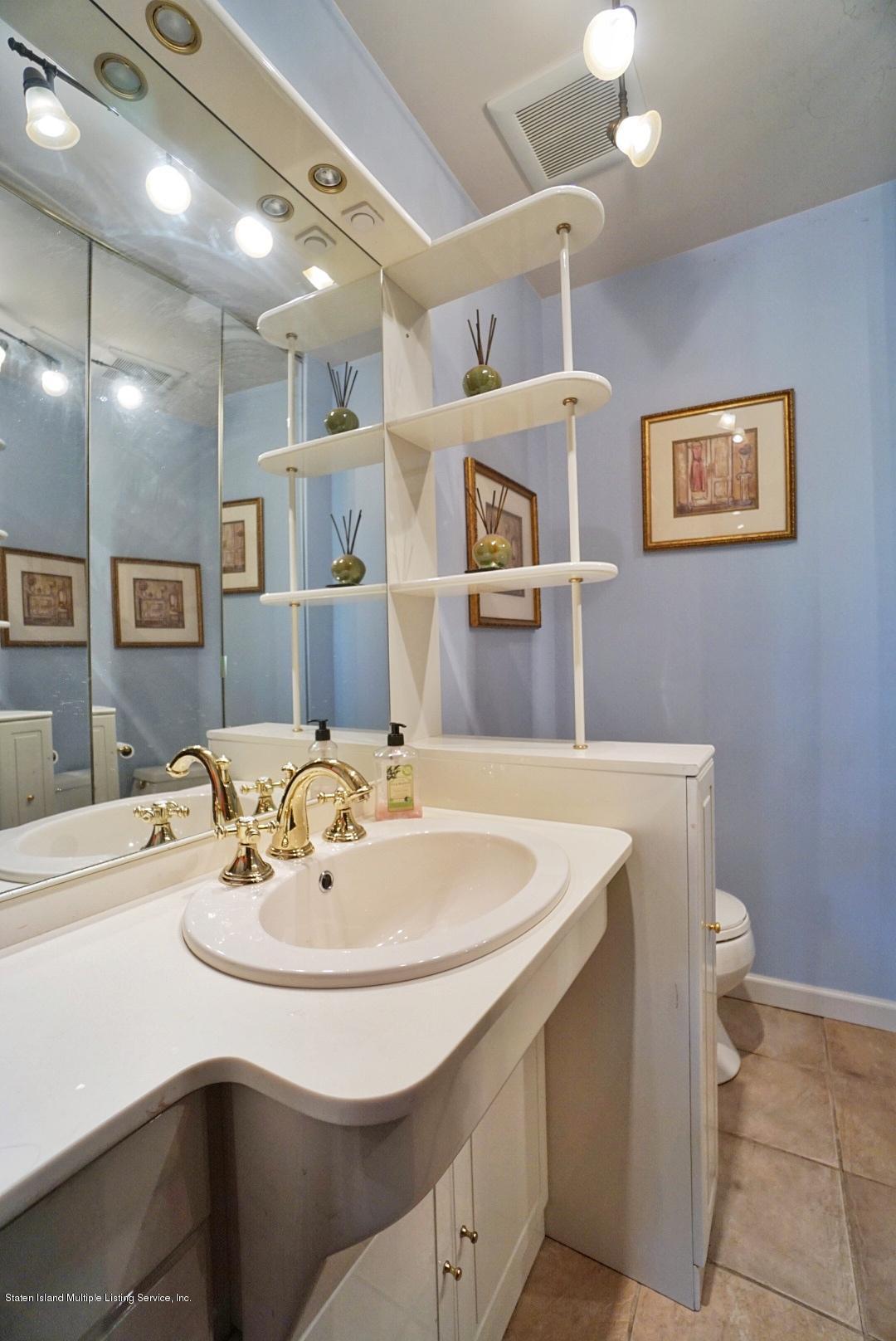 178 Admiralty Loop Staten Island, NY 10309 - Photo 22 of 50 a bathroom with a sink a mirror and a toilet