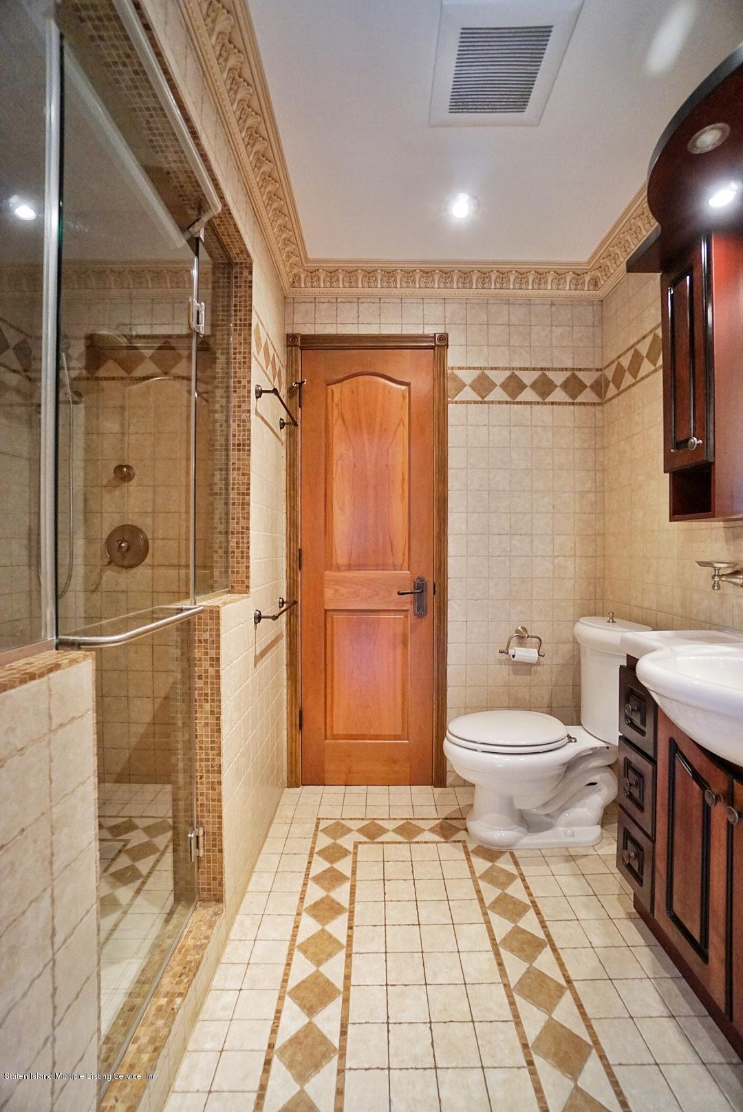 178 Admiralty Loop Staten Island, NY 10309 - Photo 30 of 50 a bathroom with a toilet a sink and shower