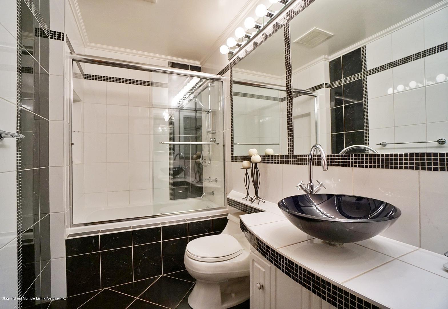 178 Admiralty Loop Staten Island, NY 10309 - Photo 36 of 50 a bathroom with a sink and a mirror