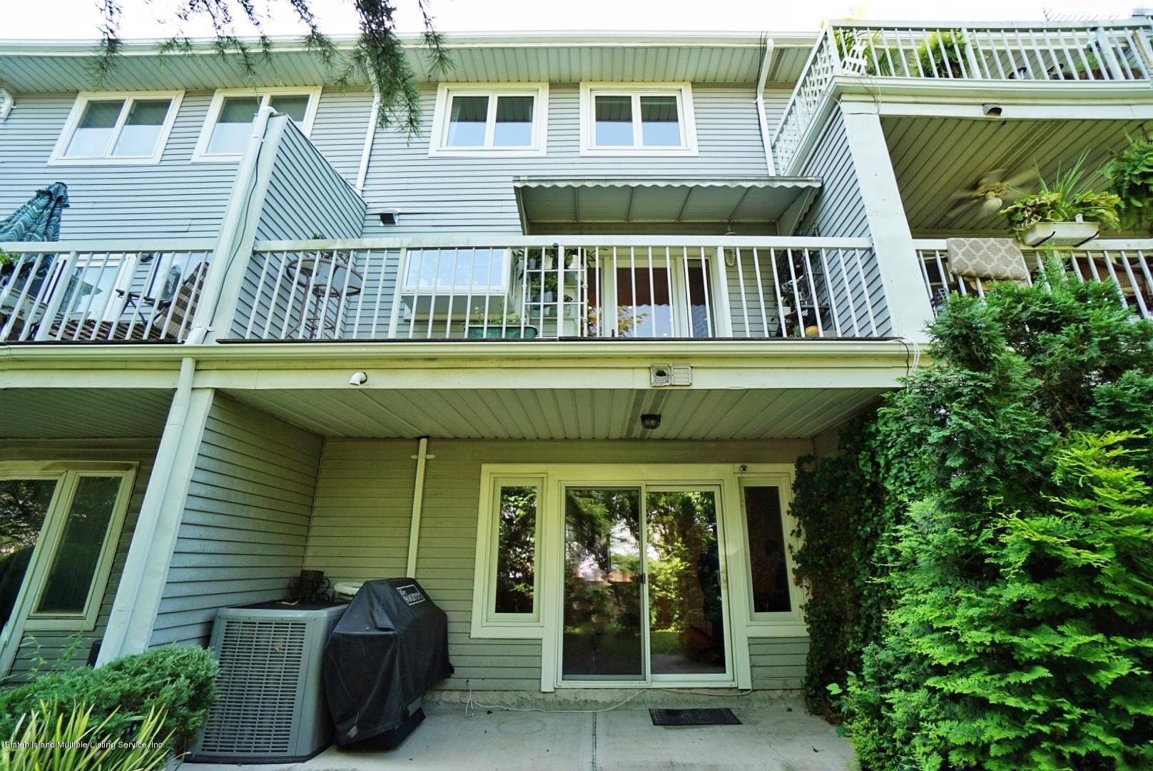 178 Admiralty Loop Staten Island, NY 10309 - Photo 37 of 50 a view of a house with large windows and a table and chairs
