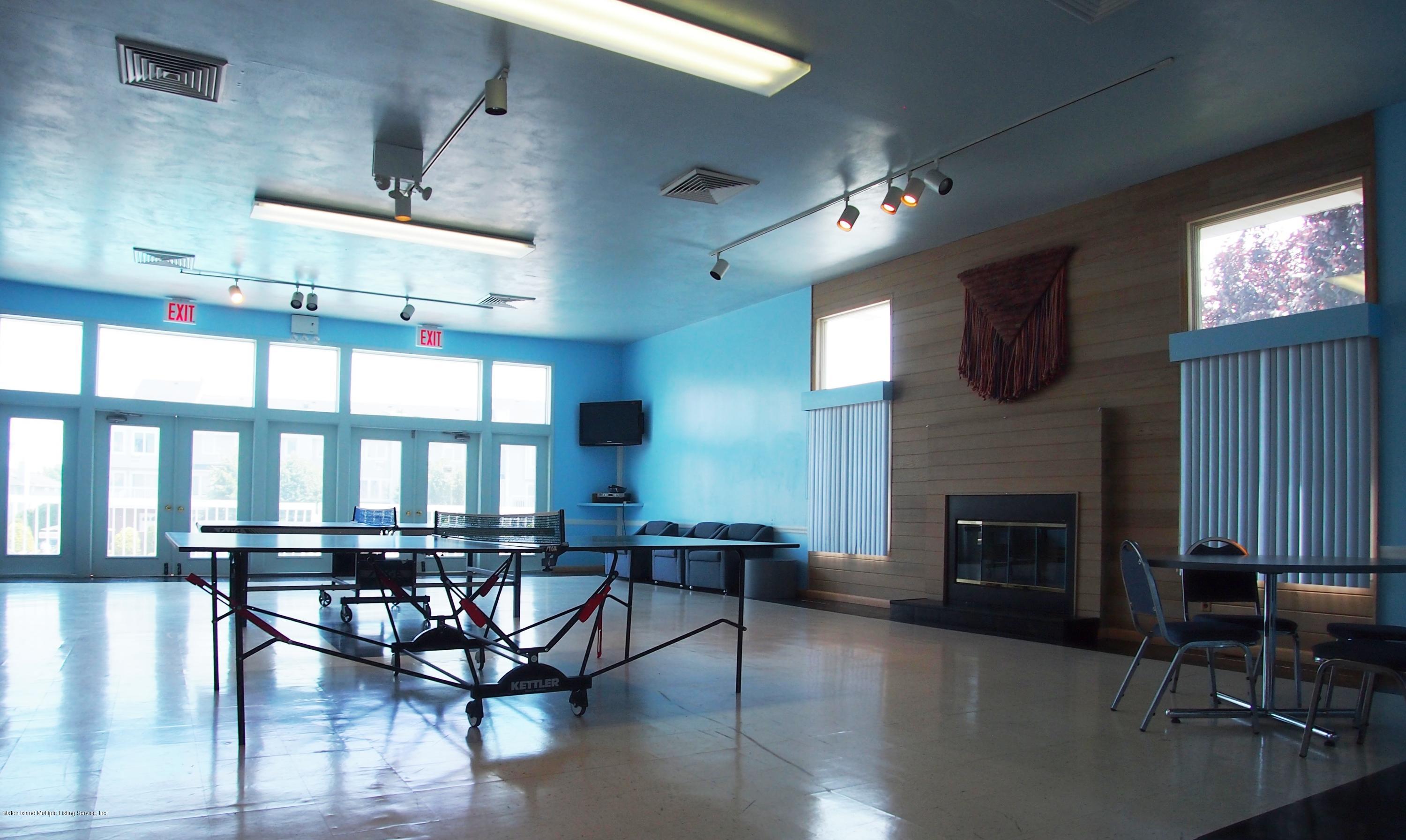 178 Admiralty Loop Staten Island, NY 10309 - Photo 45 of 50 a living room with furniture a fireplace and a flat screen tv