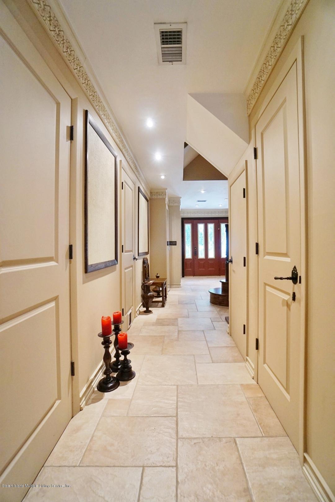 178 Admiralty Loop Staten Island, NY 10309 - Photo 5 of 50 a view of a hallway with dining area and chandelier