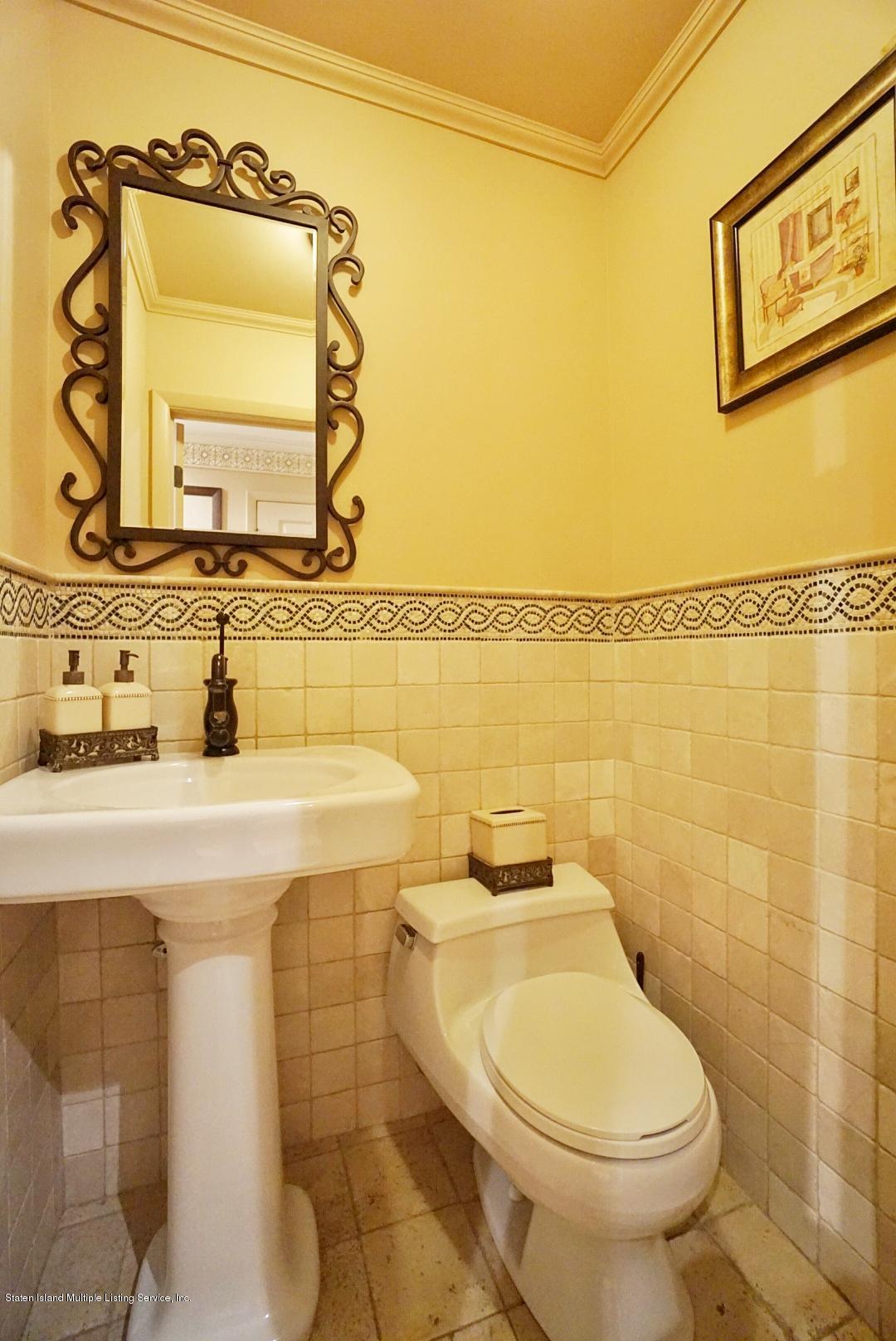 178 Admiralty Loop Staten Island, NY 10309 - Photo 6 of 50 a bathroom with a toilet sink and mirror