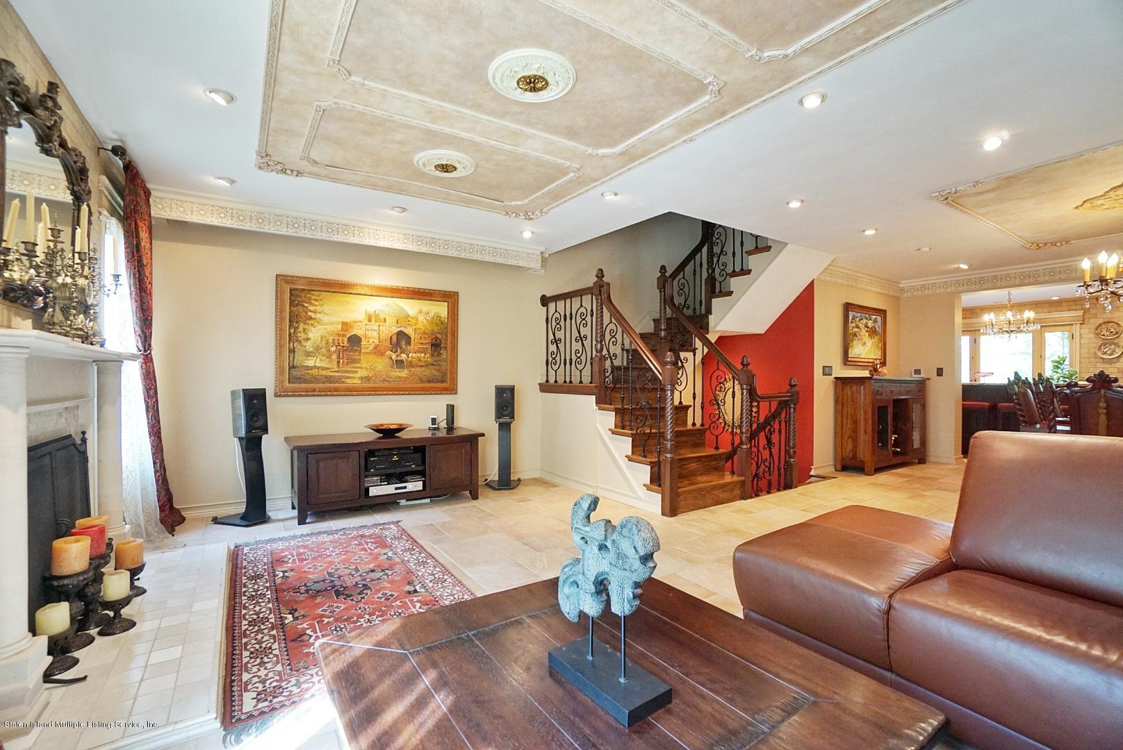 178 Admiralty Loop Staten Island, NY 10309 - Photo 10 of 50 a living room with furniture flat screen tv and a fireplace