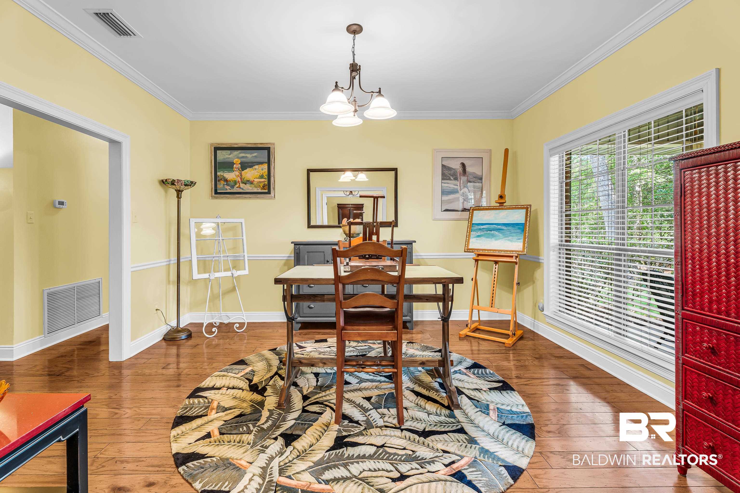 7014 Blakeley Road Daphne, AL 36527 - Photo 22 of 45 Spacious room featuring wood-finish flooring, a large window with blinds, and an overhead chandelier