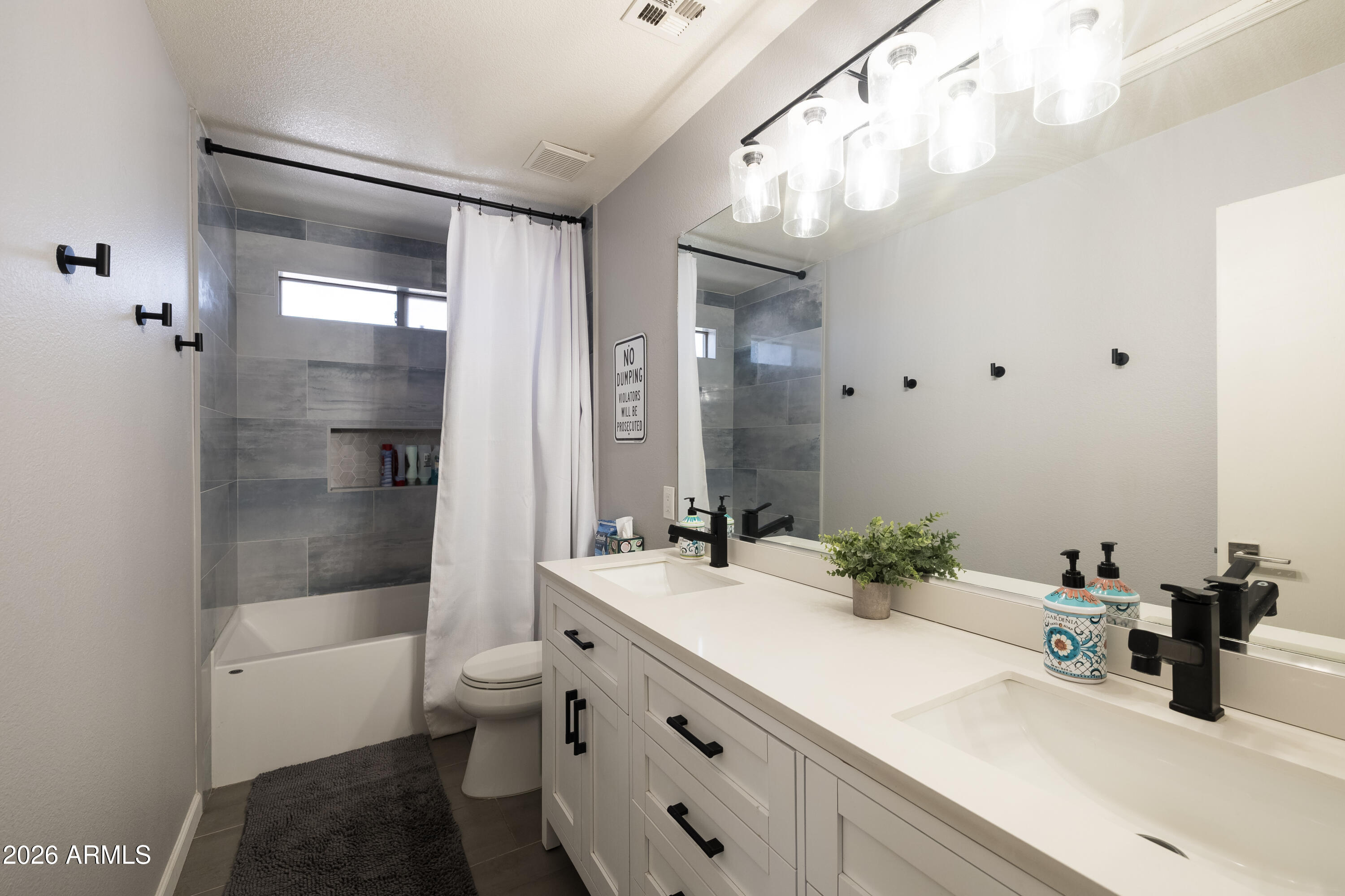 6407 West Saddlehorn Road Phoenix, AZ 85083 - Photo 31 of 41 a bathroom with a double vanity sink toilet mirror and shower