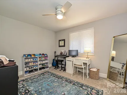 a view of a workspace with furniture and a window