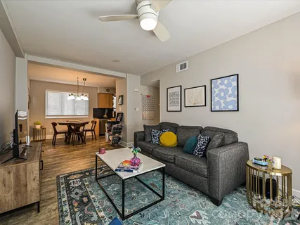 a living room with furniture a rug and a chandelier
