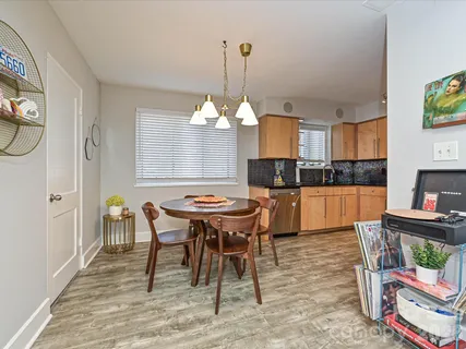 a view of a dining room with furniture and chandelier