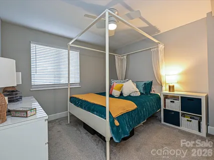 a bedroom with a bed and a table