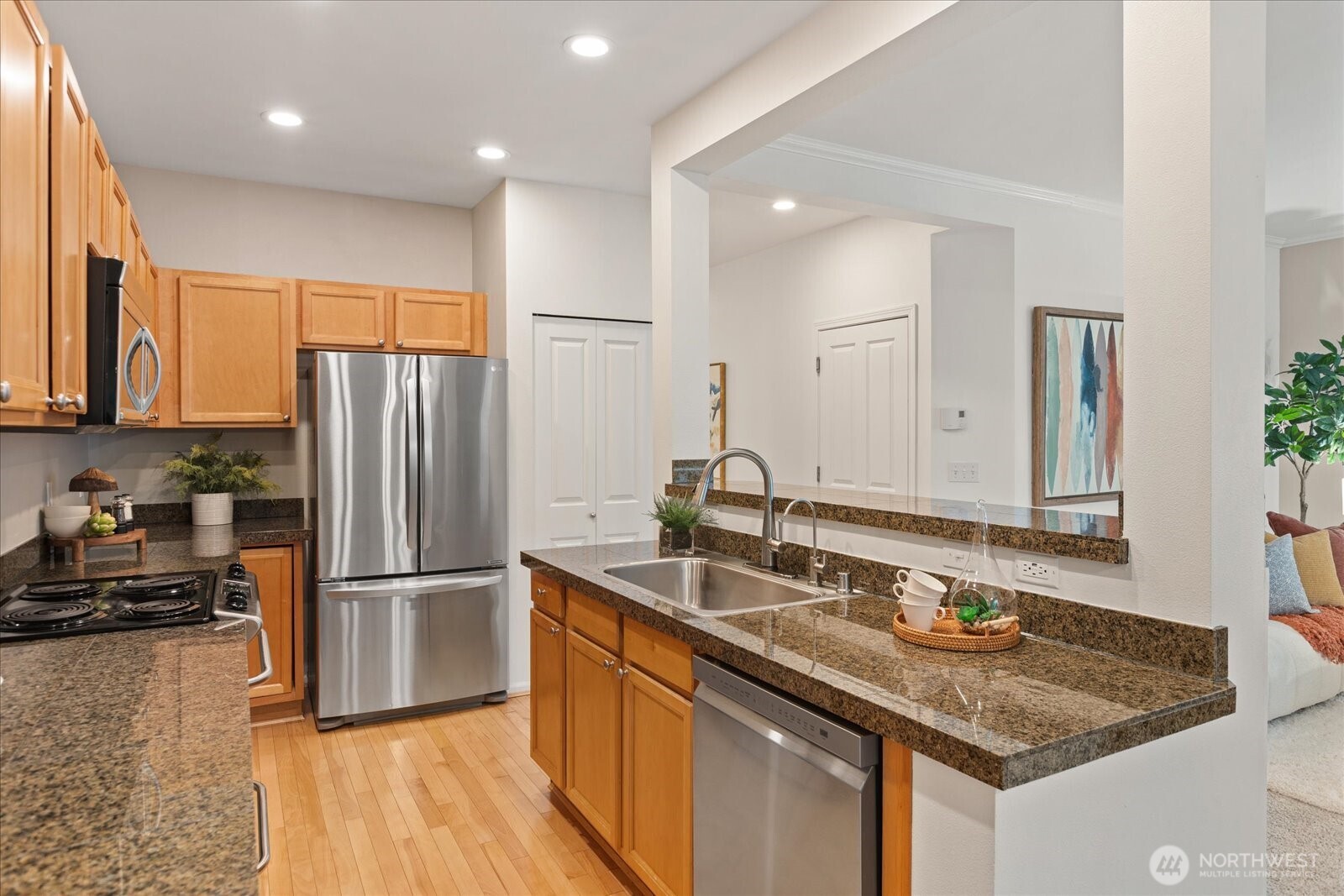 6011 29th Avenue Southwest Seattle, WA 98126 - Photo 8 of 29 a kitchen with kitchen island granite countertop a sink appliances and cabinets
