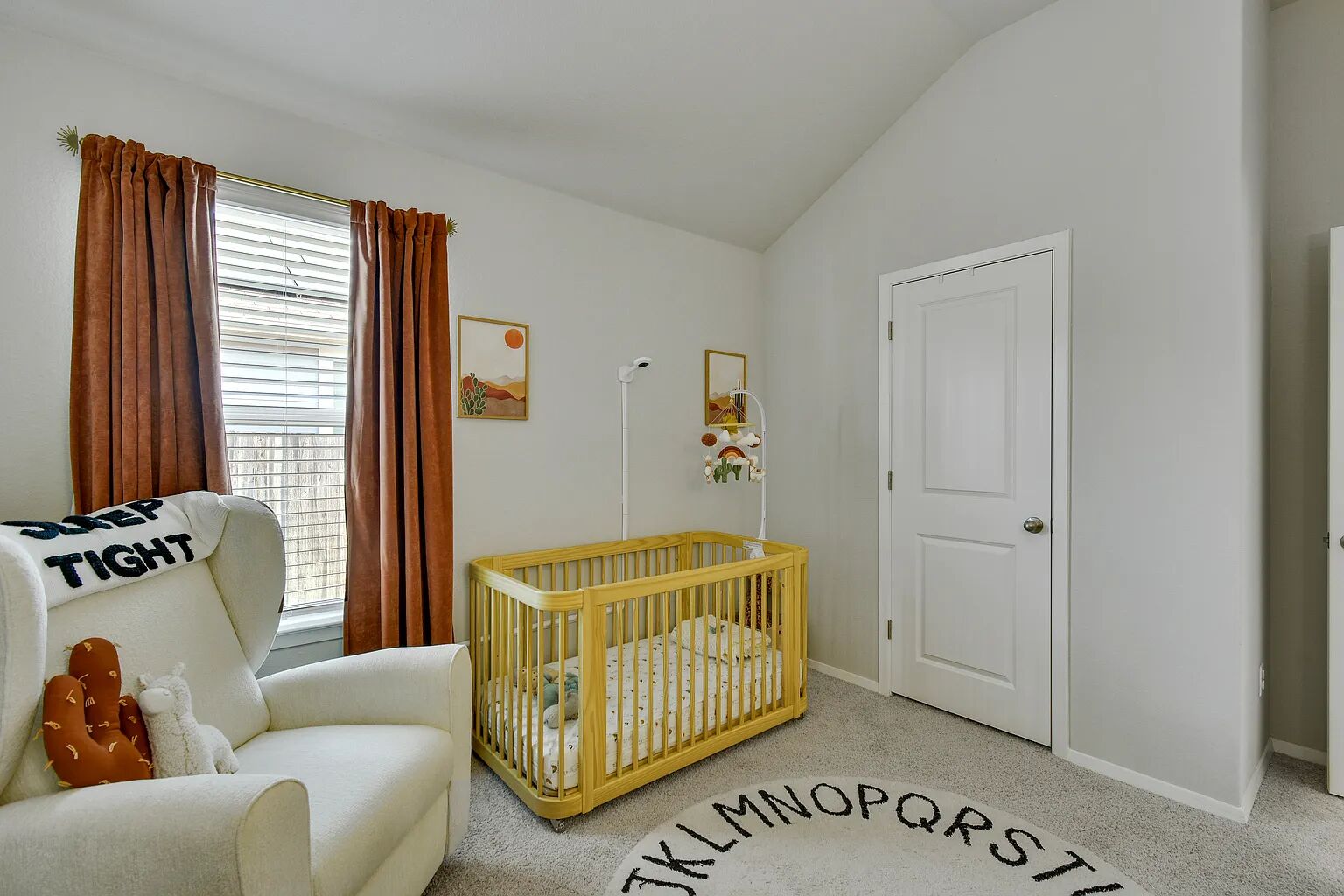121 Crescent Street Georgetown, TX 78626 - Photo 15 of 27 Bedroom featuring a crib, lofted ceiling, and light carpet
