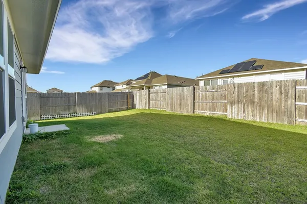 a view of a house with a backyard