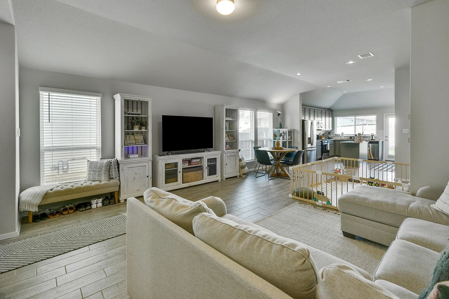 121 Crescent Street Georgetown, TX 78626 - Photo 6 of 27 Living area featuring wood finish floors, vaulted ceiling, and recessed lighting