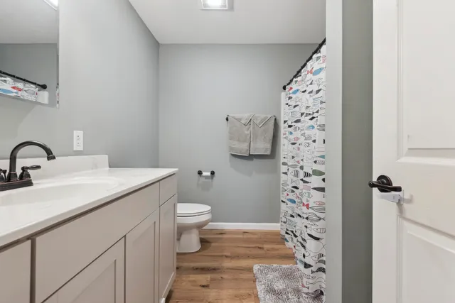 a bathroom with a sink toilet and shower